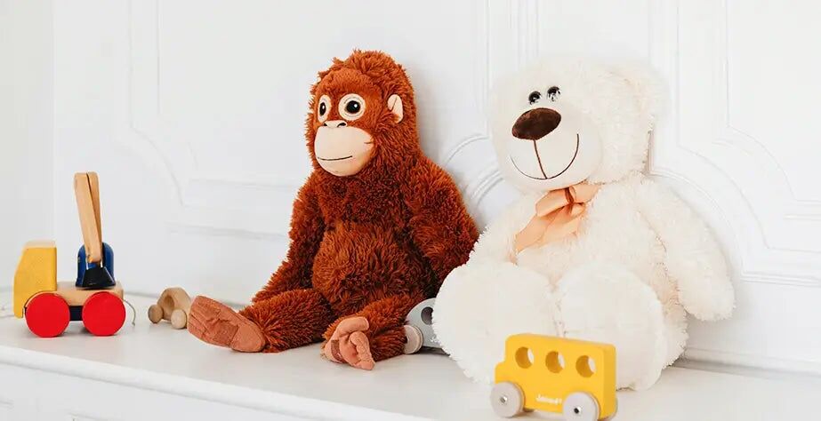 Brown gorilla plush toy and white bear plush toy